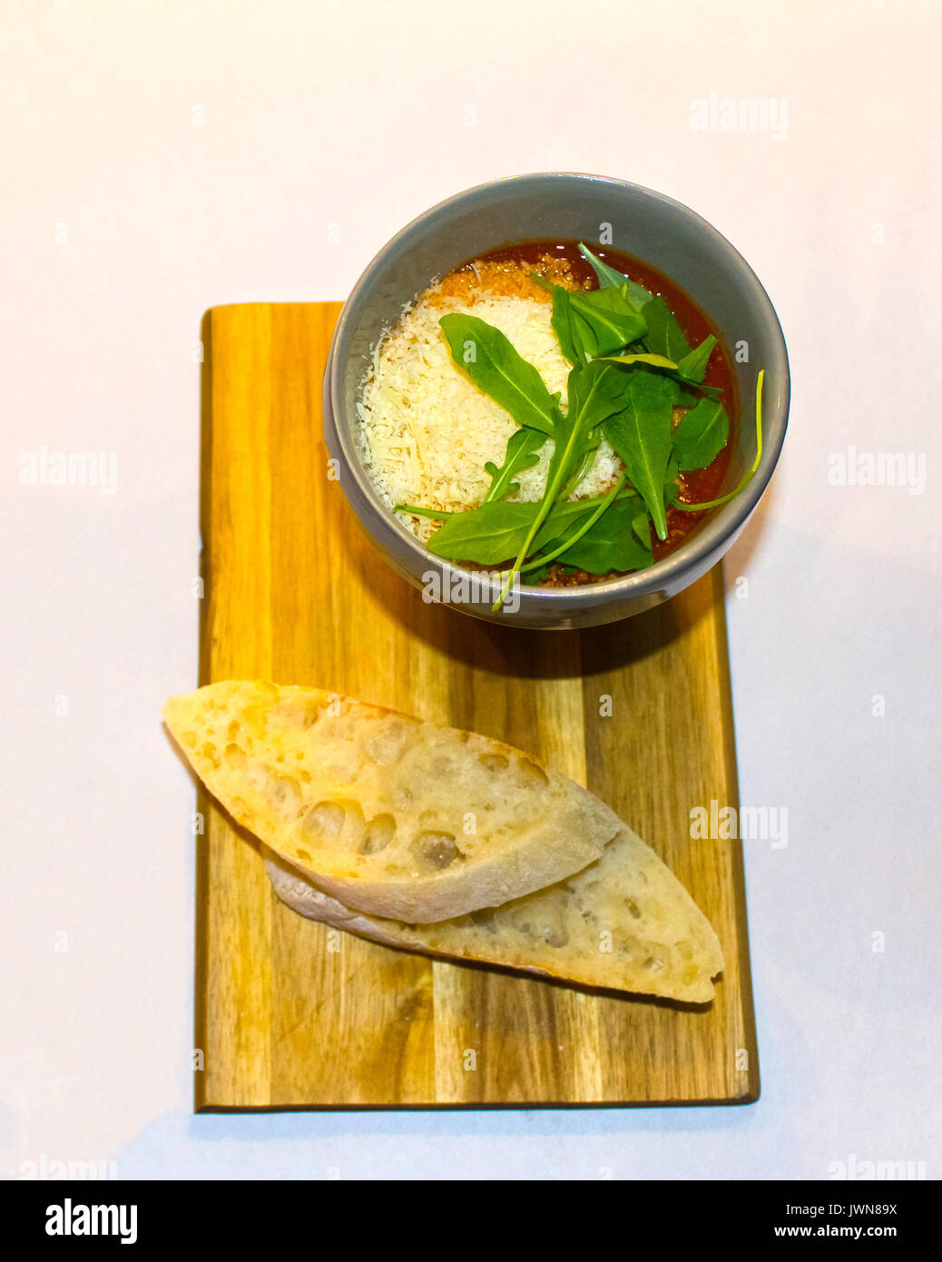 A bowl of fresh tomato soup garnished with herbs Stock Photo - Alamy