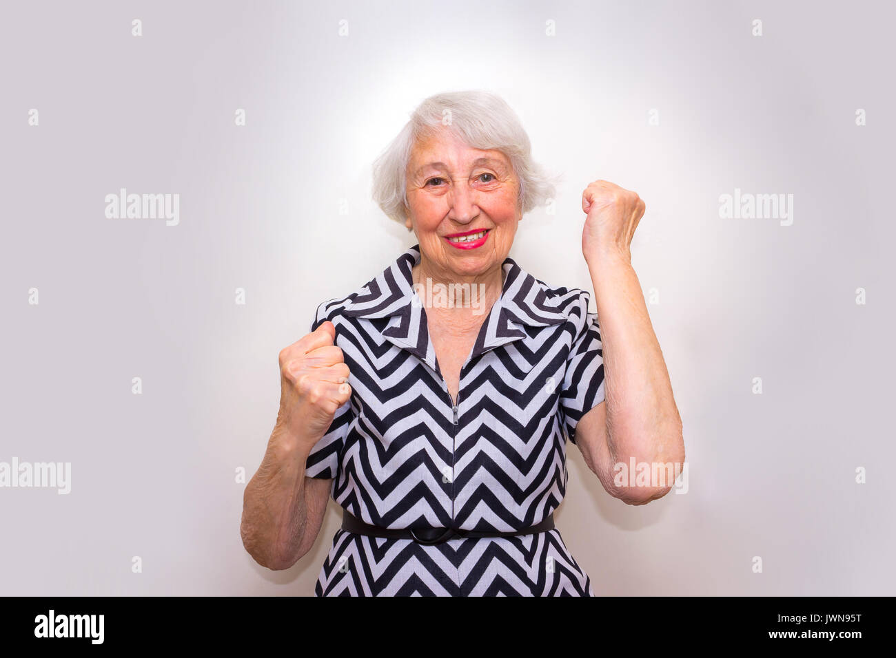 Old woman celebrating a win hi-res stock photography and images - Alamy