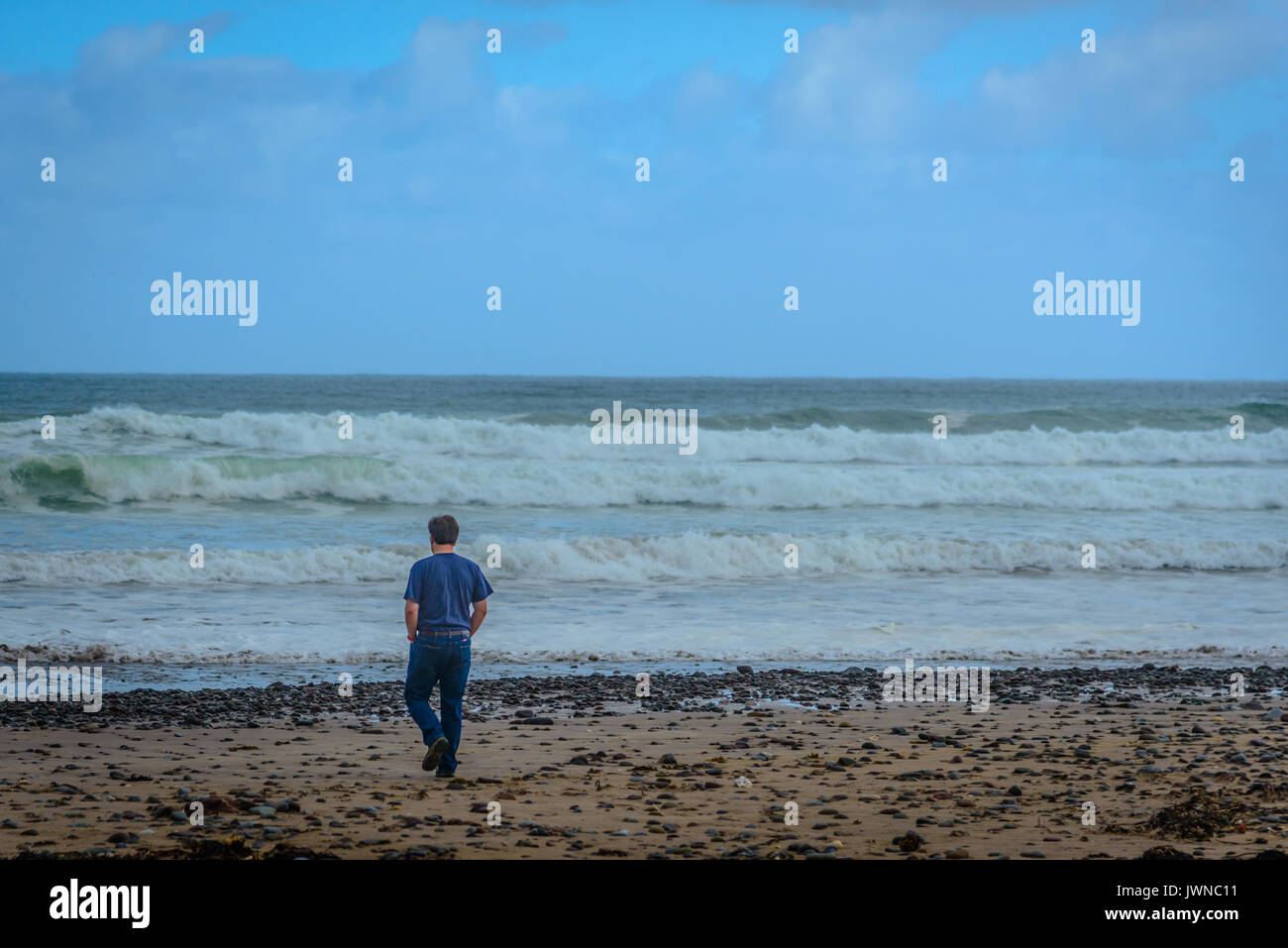 Man Walking Away on a Beach Stock Photo - Alamy