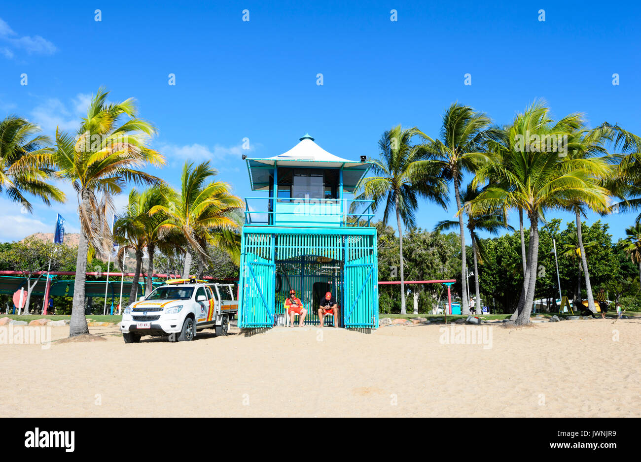 Turquoise Lifeguard Hut on scenic tropical sandy beach with palm trees, Townsville, Queensland, QLD, Australia Stock Photo