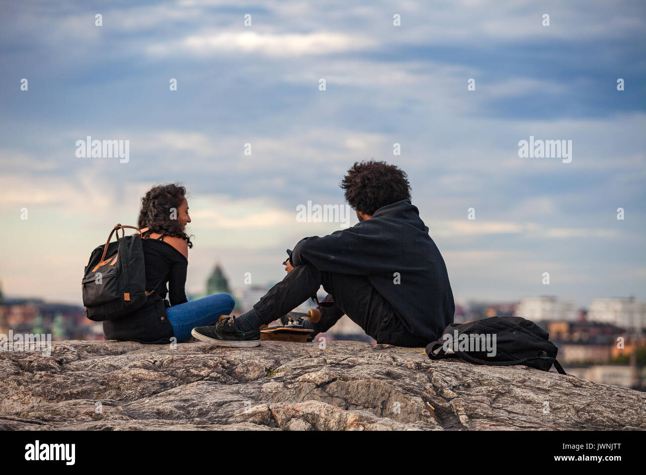 STOCKHOLM, SWEDEN - SEPTEMBER 16, 2016: Tourists couple is enjoying cityscapes of old town from rock Stock Photo