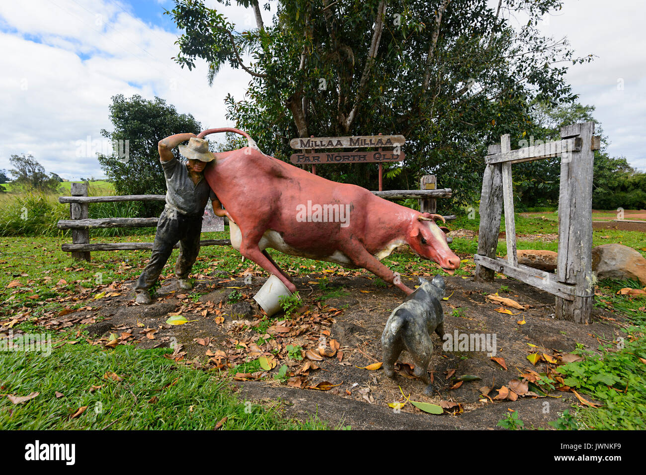Humorous statue depicting a farmer attempting to milk a cow with his dog causing mayhem, Millaa Millaa, Far North Queensland, FND, QLD, Australia Stock Photo
