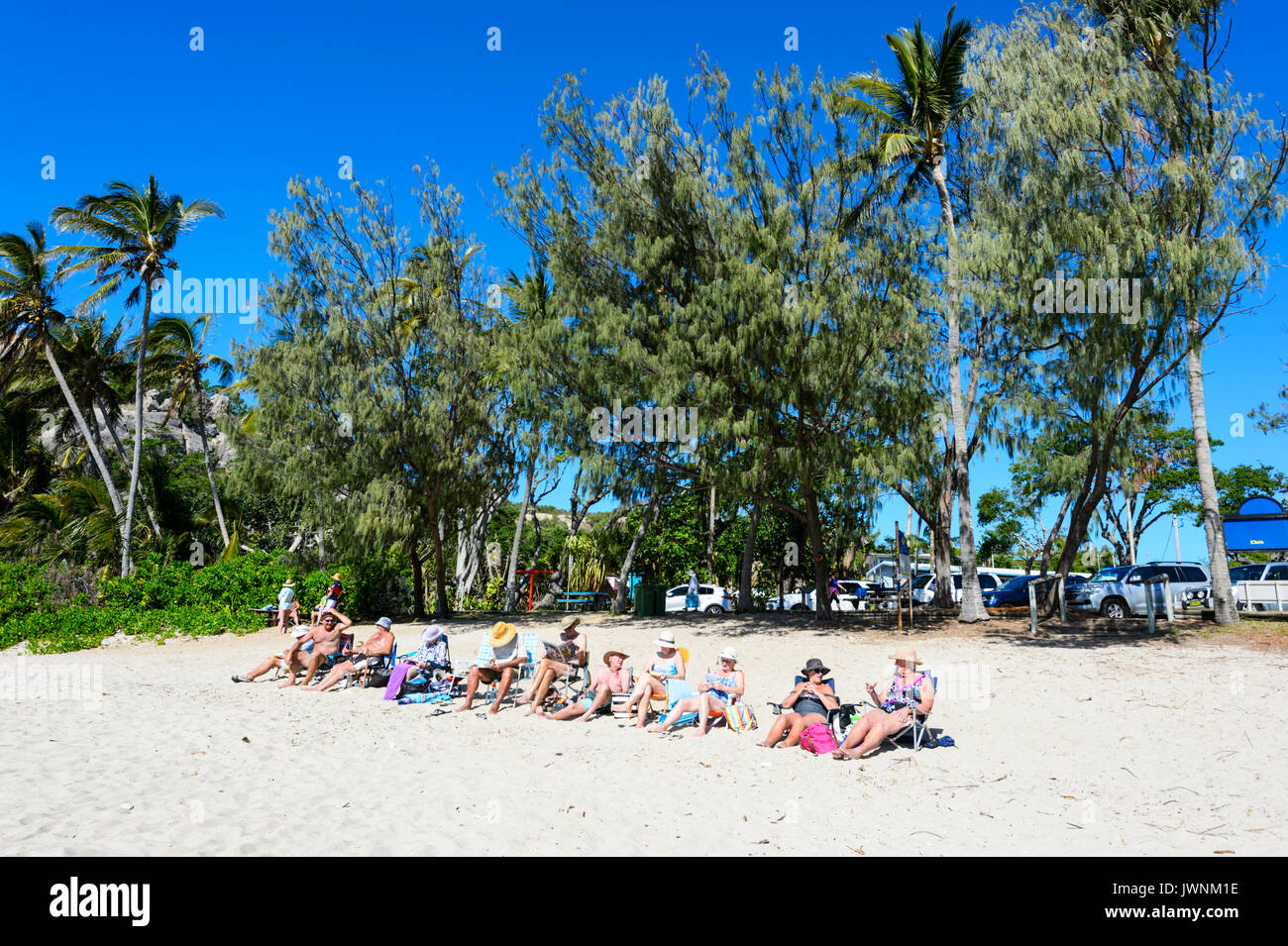 Row Of People Relaxing On The Beach Horseshoe Bay Bowen Stock Photo Alamy