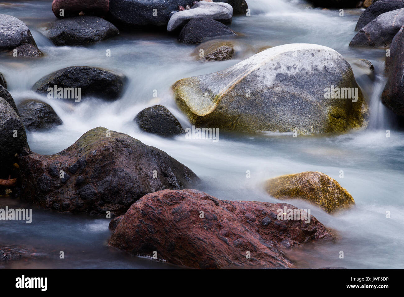 Nature detail: water stream which goes among big stones Stock Photo - Alamy