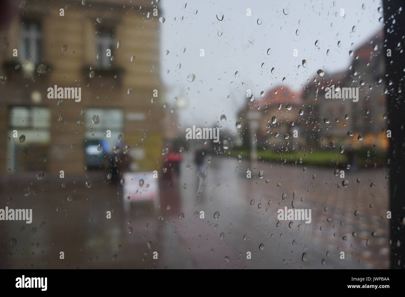 Raindrops on the glass window during rainy day in Timisoara, Romania Stock Photo