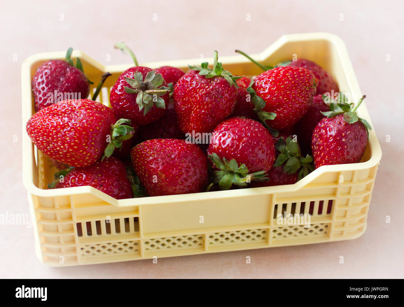 Strawberry in the yellow plastic box Stock Photo - Alamy