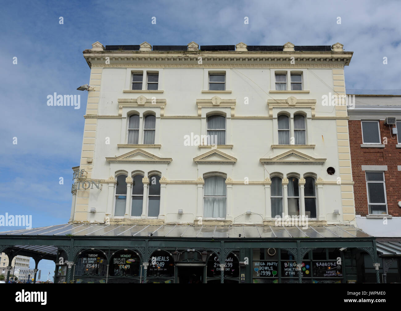 White rendered building with glass and iron verandah in Llandudno conwy ...