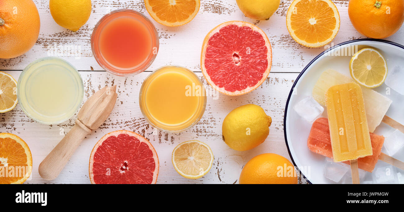 Plate with sliced citrus and two glasses of juice. Stock Photo