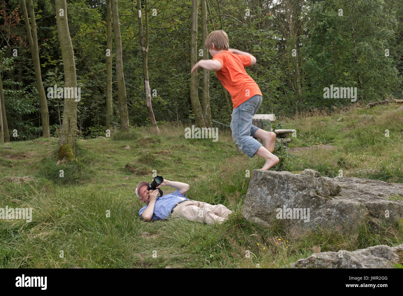 man taking photo of jumping boy Stock Photo