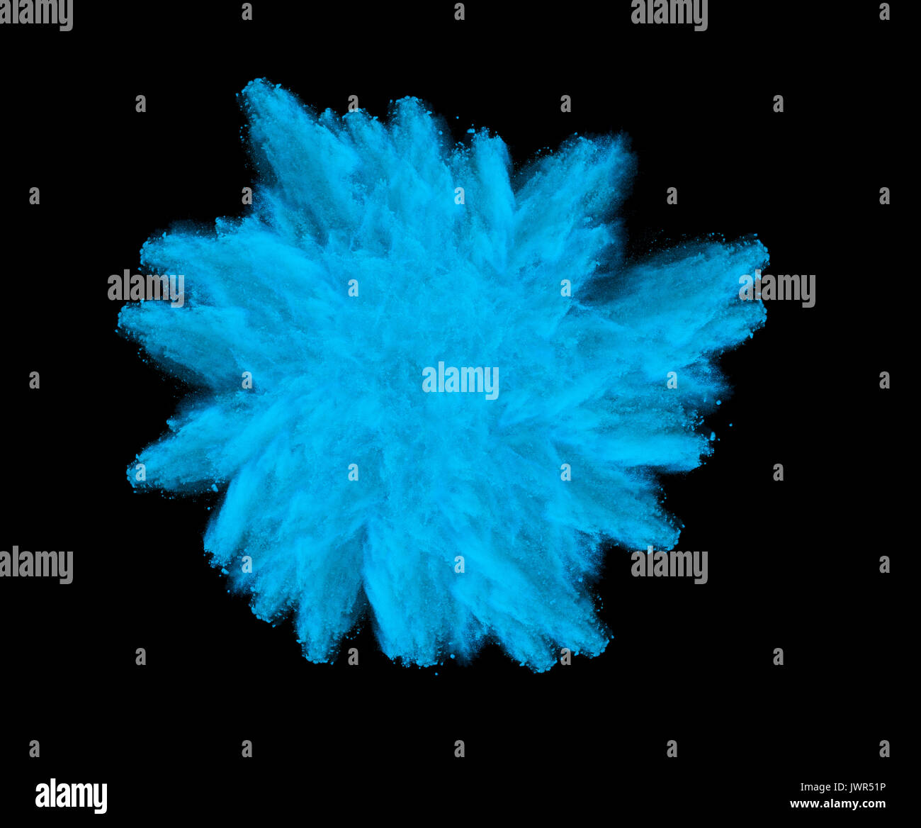 Freeze motion of blue dust explosion isolated on black background Stock Photo
