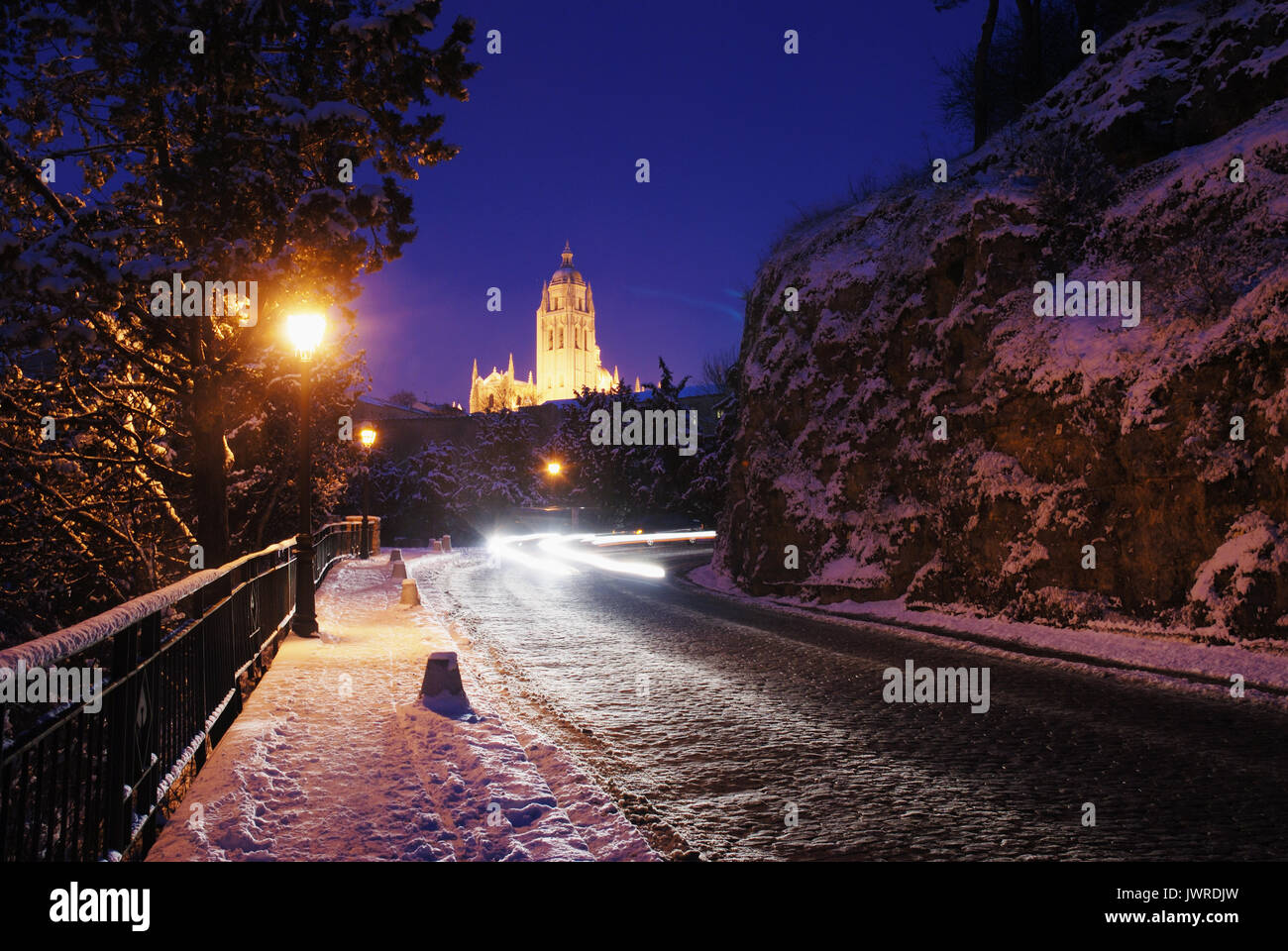 Snow covered road and cathedral, night view. Segovia, Spain. Stock Photo