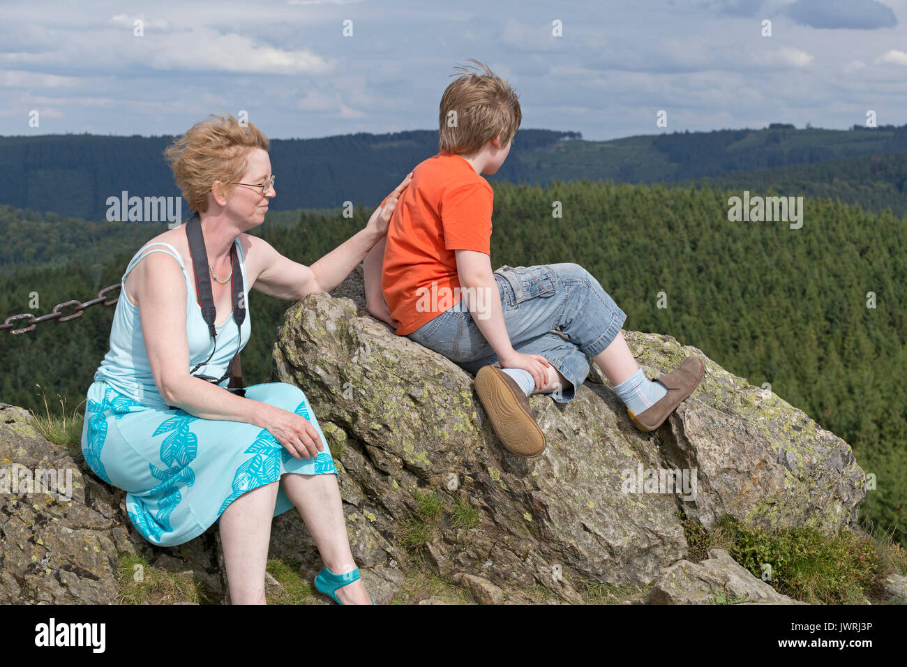 mother and son on the summit of Feldstein, Bruchhausen Rocks, Sauerland, Northrhine-Westfalia, Germany Stock Photo