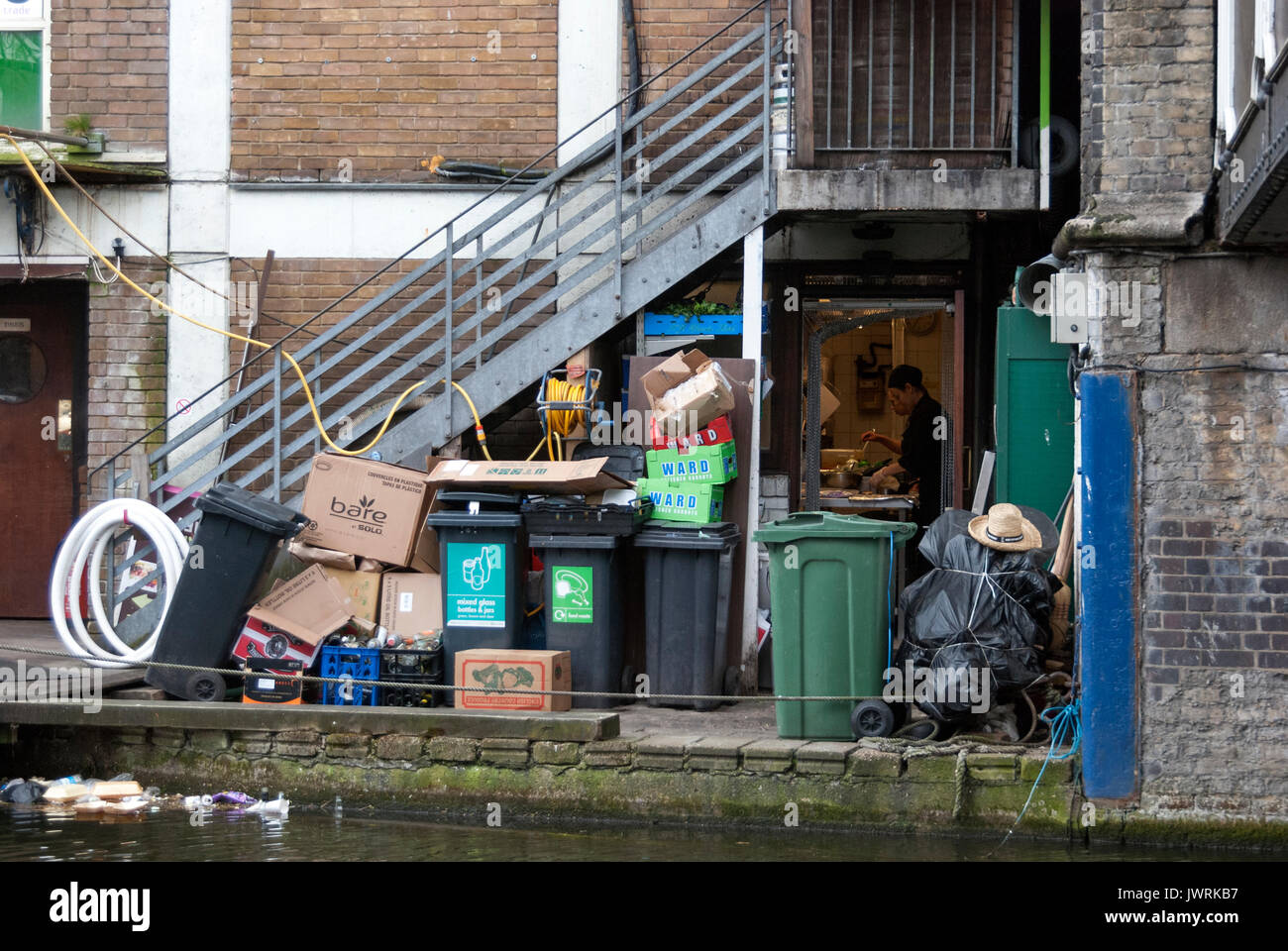 London England, Camden Lock, Rubbish at Back Door of Kitchen Entrance, Person Cooking with Kitchen Door Open, Rubbish in Lake, Bins Full, Market Area Stock Photo