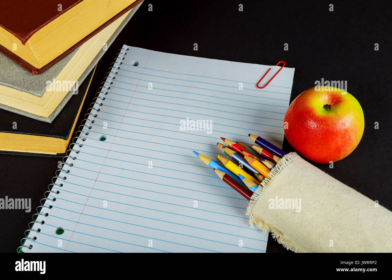 back to school concept isolated on black background Blank Notebook, Pencil, Pen, Ruler and Scissors on Wooden Background Stock Photo