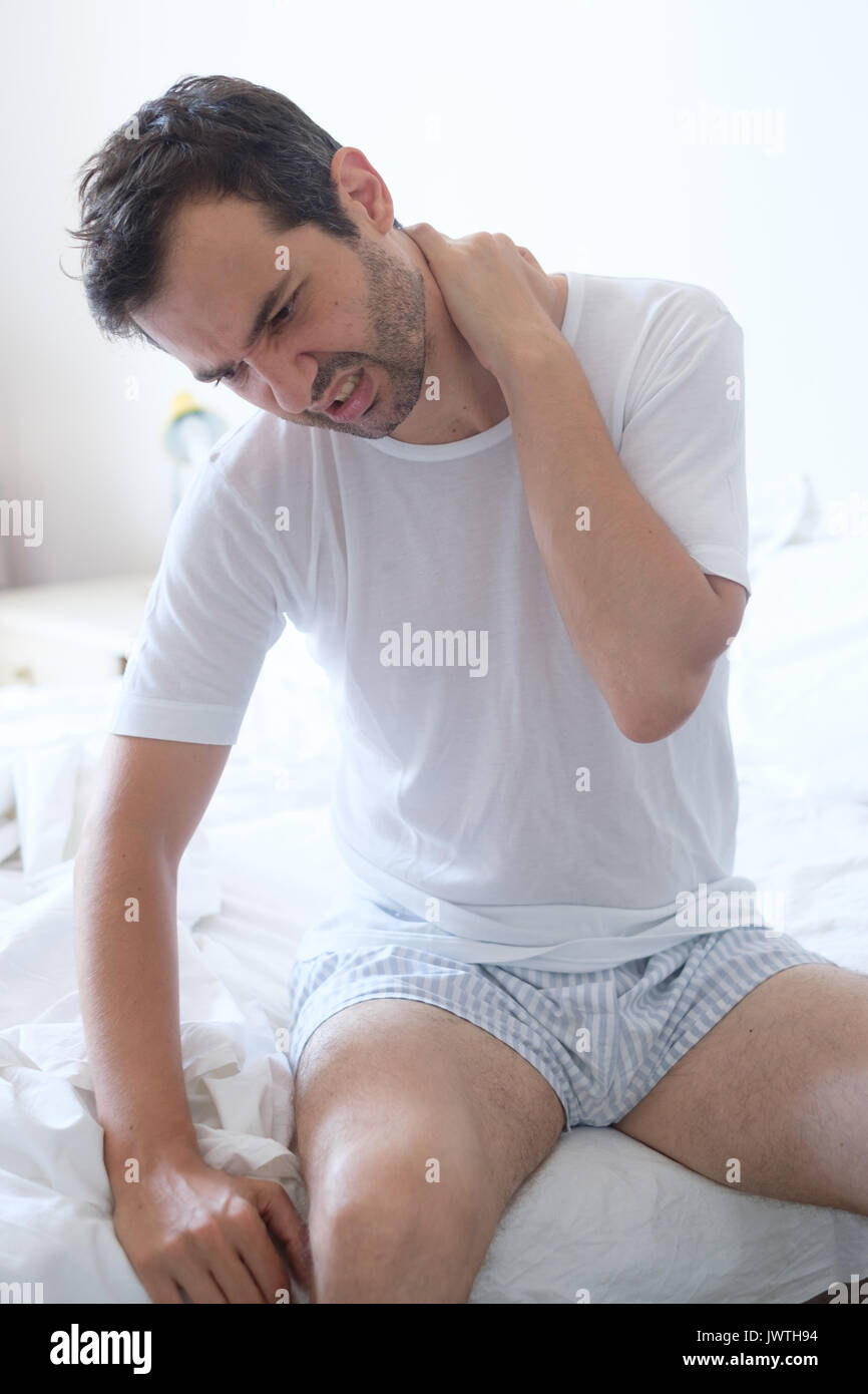 Man feeling back ache in the bed after sleeping Stock Photo Alamy