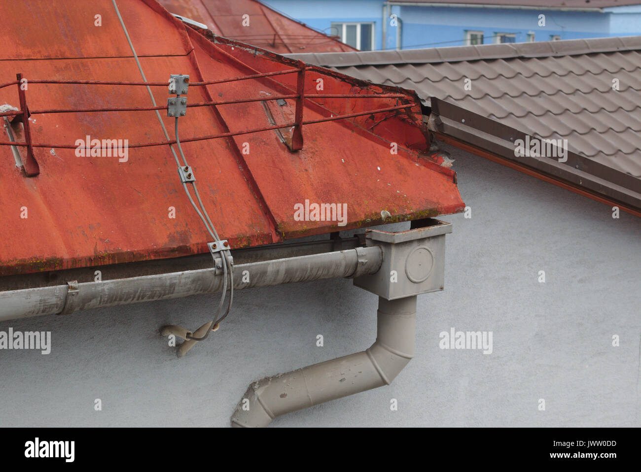 Rusty metal roof with gutter and lightning conductor Stock Photo