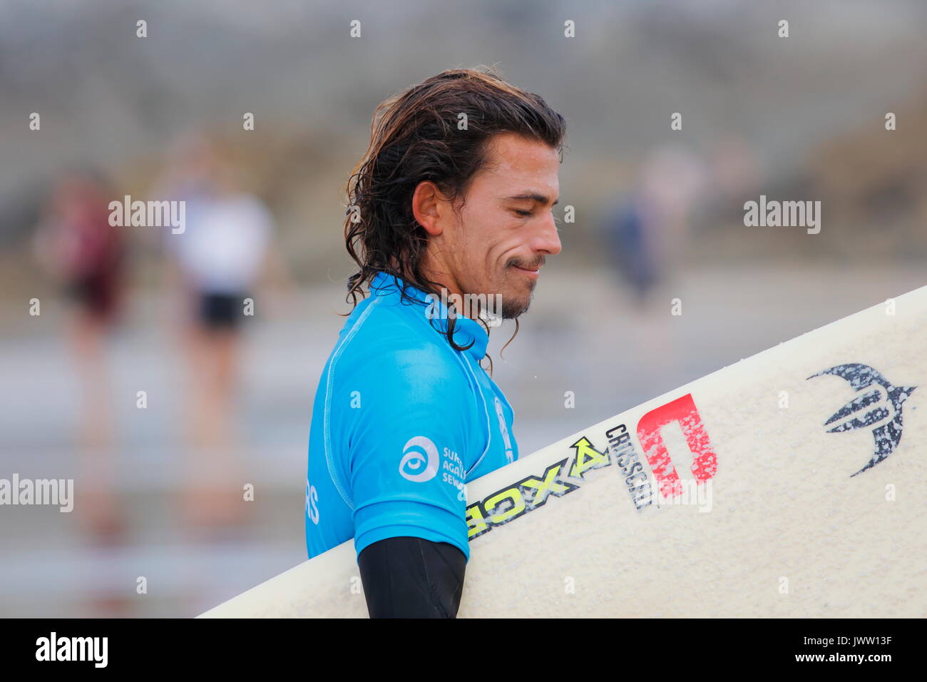 Fistral Beach, Newquay, Cornwall, UK. 13th Aug, 2017. Surfers take part in Day 5 of the Boardmasters Championship. This featured longboard surfers from around the world including Edouard Delpero seen here. Credit: Nicholas Burningham/Alamy Live News Stock Photo