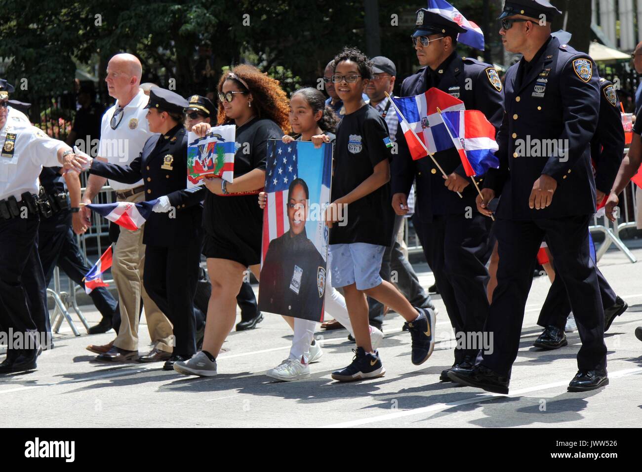 New York, NY, US. 13th. Aug, 2017. This year’s 35th. annual Dominican Day Parade in midtown Manhattan honored NYPD Officer Miosotis Familia, who was killed in the line of duty in the Bronx last month . The thousands who gathered to display Dominican pride witnessed the city honor the slain officer with a posthumous lifetime service award. There is an estimated 700,000 plus citizens from the Caribbean island of the Dominican Republic living in the New York-area. © G. Ronald Lopez /DigiPixsAgain.us/Alamy Live News Stock Photo