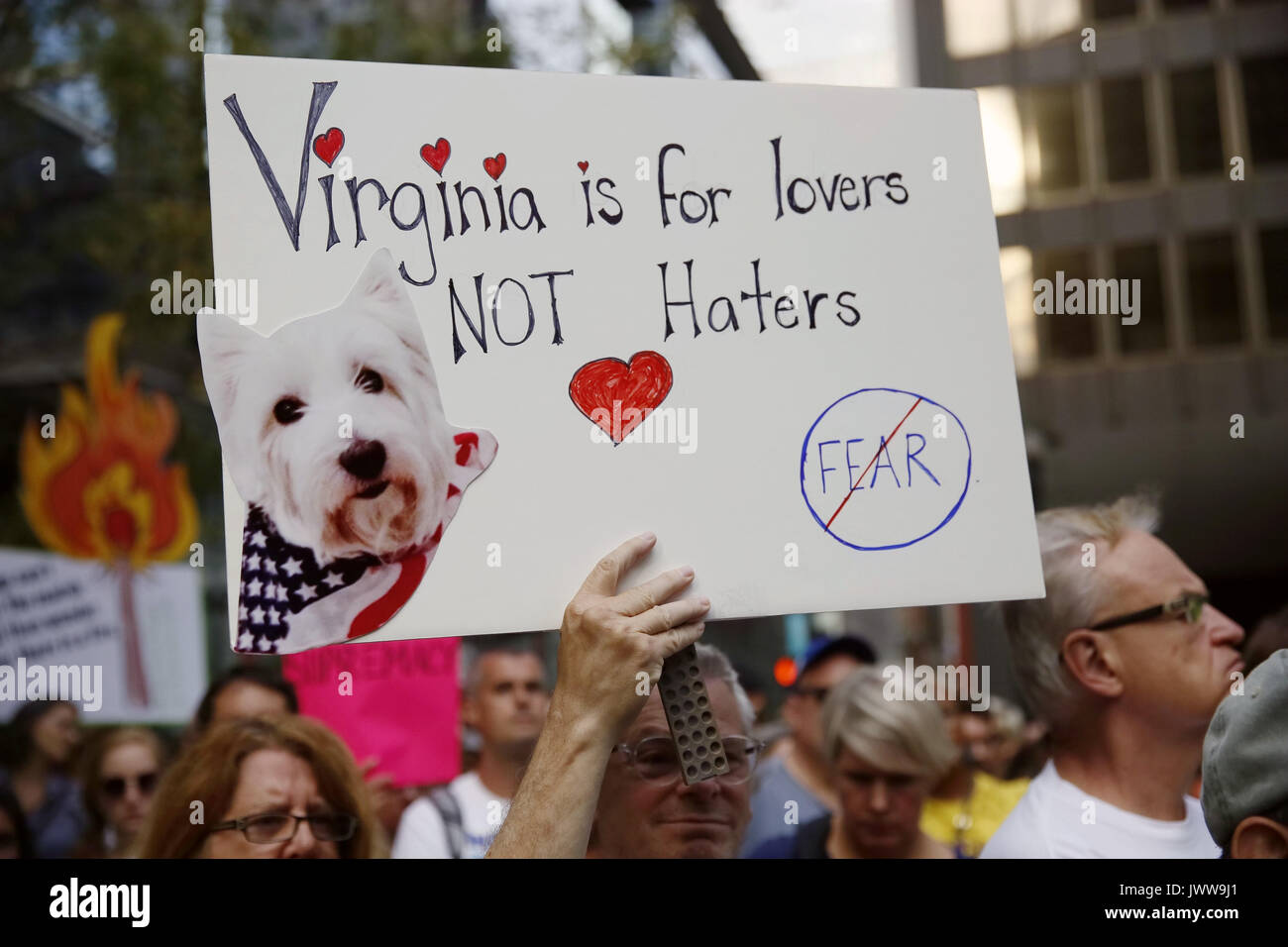 Chicago, USA. 13th Aug, 2017. A man holding a sign reads 'Virginia is for Lovers NOT Haters' participates in an evening vigil at Federal Plaza in Chicago, the United States, on Aug. 13, 2017. Several hundred people joined a Sunday evening vigil at Federal Plaza in downtown Chicago, for those who fell victim to the violence in Charlottesville of Virginia during the weekend. Credit: Wang Ping/Xinhua/Alamy Live News Stock Photo