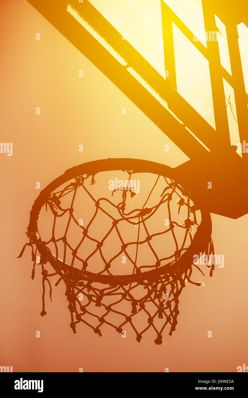 Basketball hoop on amateur outdoor basketball court for streetball, against strong summer sunlight Stock Photo