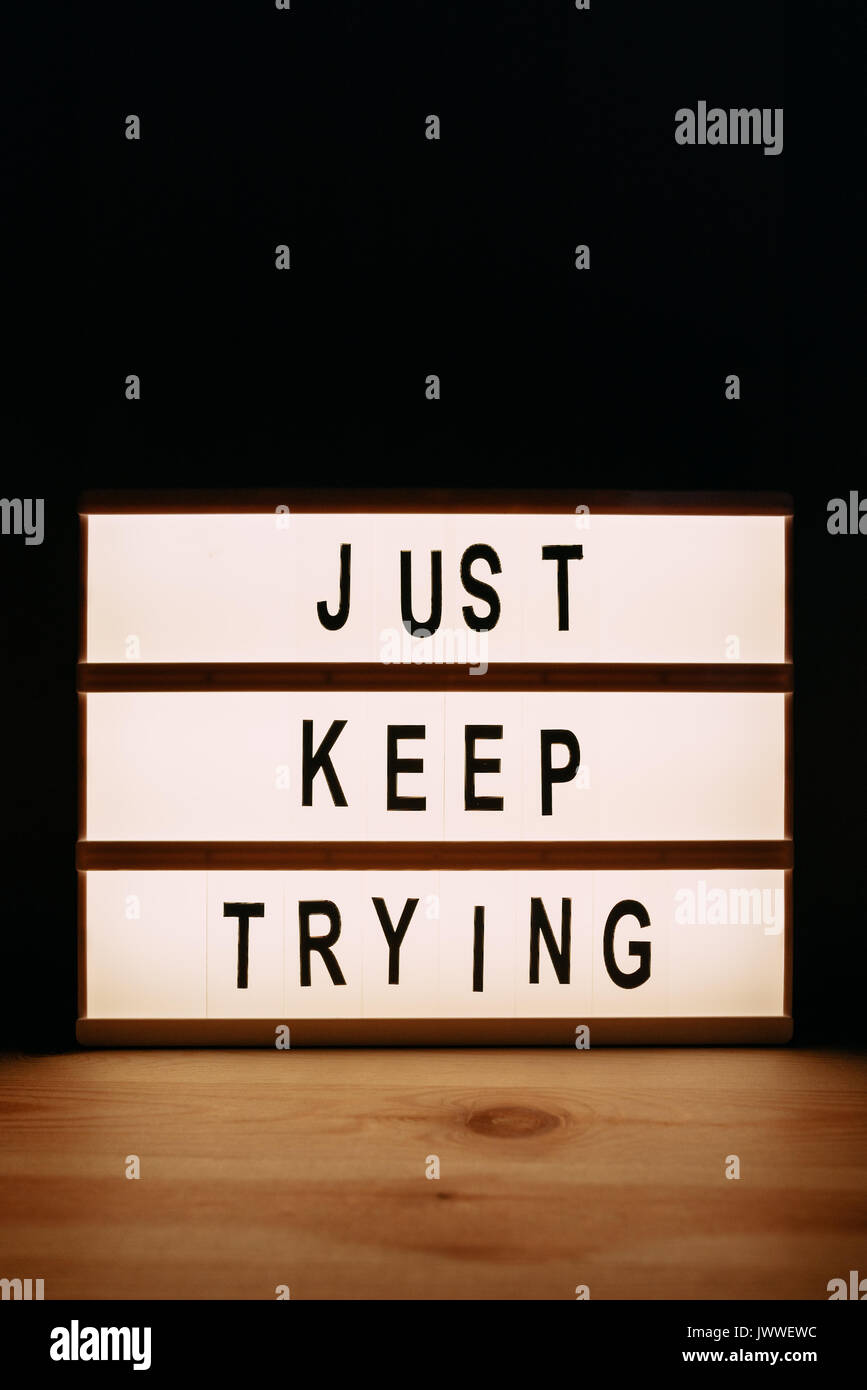 Just keep trying, motivational message on lightbox Stock Photo