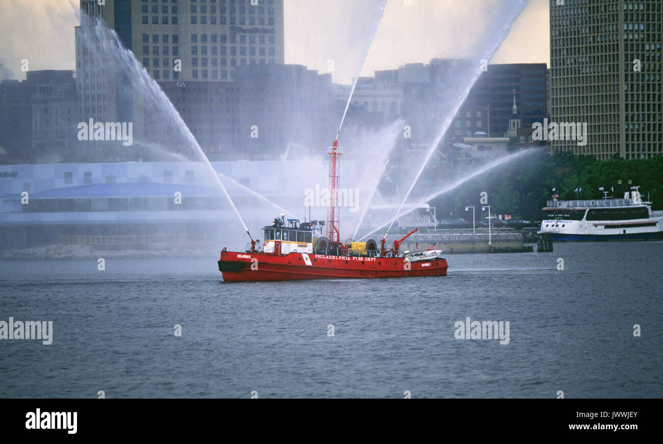 A working fireboat sprays water in Philadelphia, Pensylvania, harbor. Stock Photo