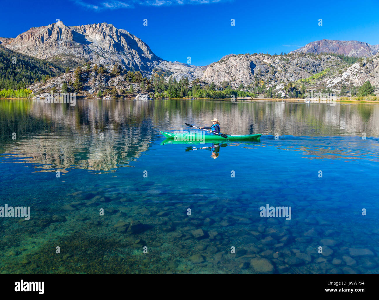 Kayaker paddles in Gull Lake in June Lake, in the Eastern Sierra of  California Stock Photo