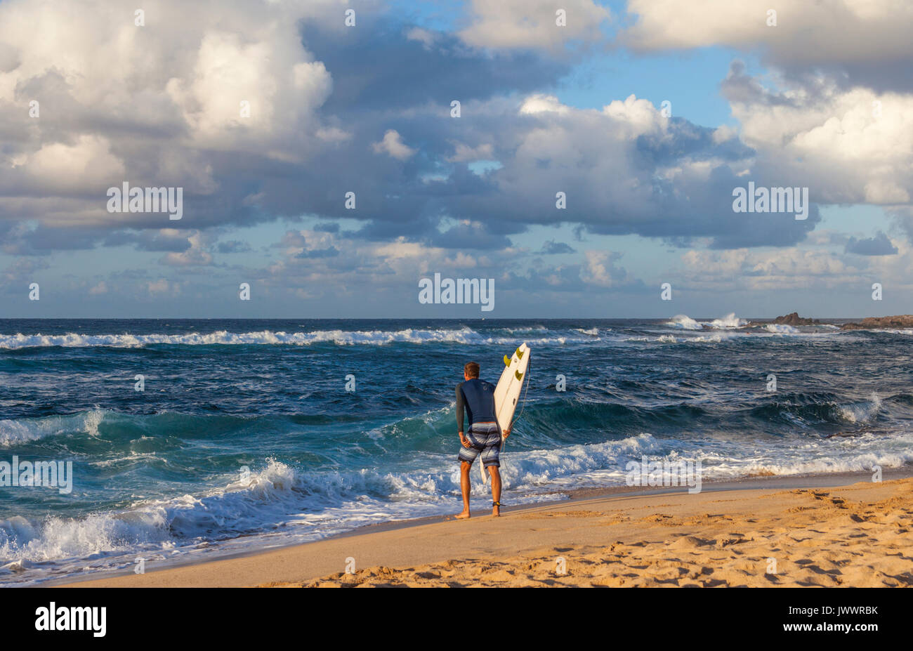 Surfer goes to the sea at Hookipa Beach on Maui Stock Photo