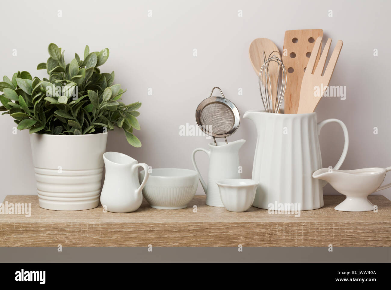 https://c8.alamy.com/comp/JWWRGA/kitchen-utensils-and-dishware-on-wooden-shelf-kitchen-interior-background-JWWRGA.jpg