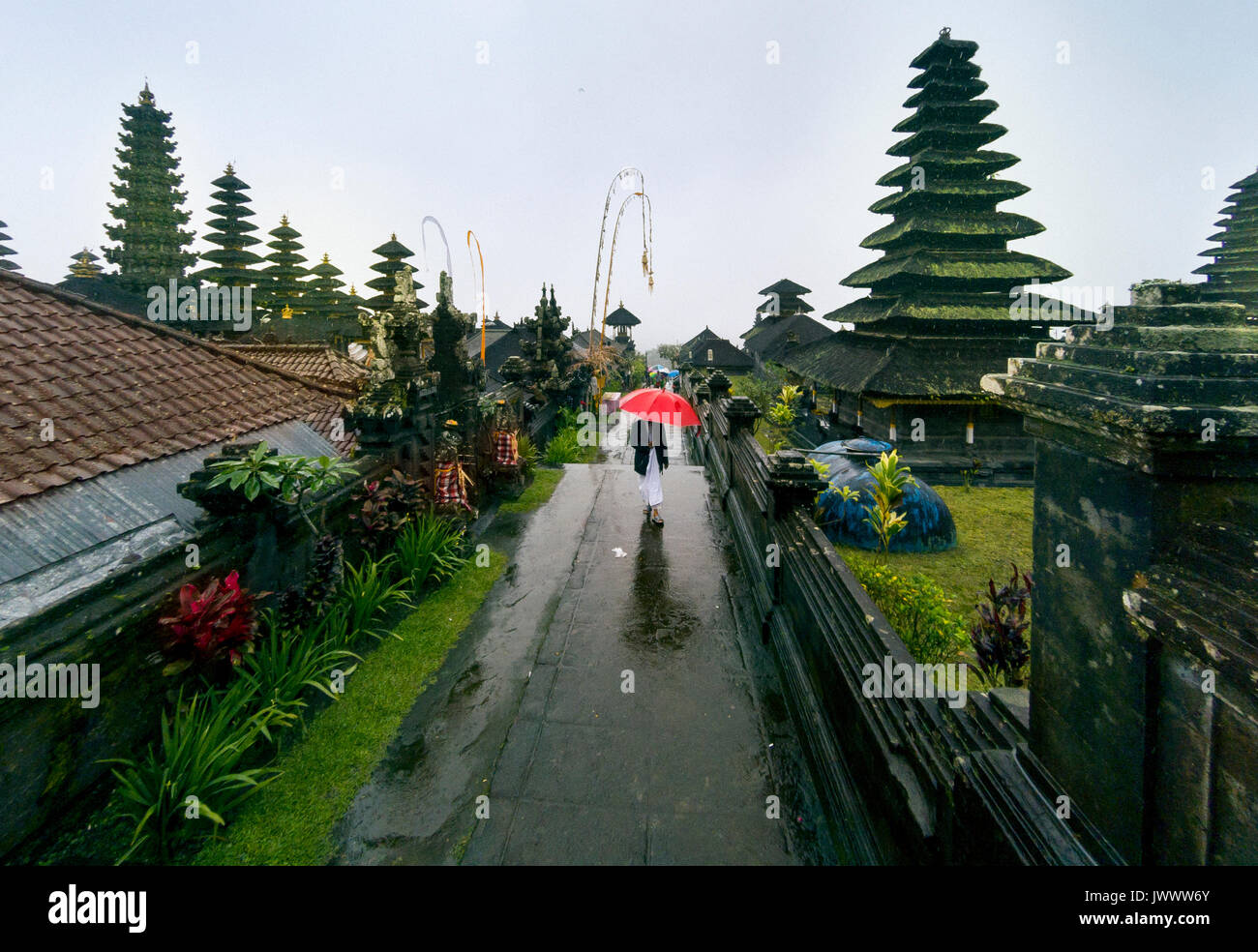 The man with red umbrella in Pura Besakih temple at Besakih Bali Indonesia. Stock Photo