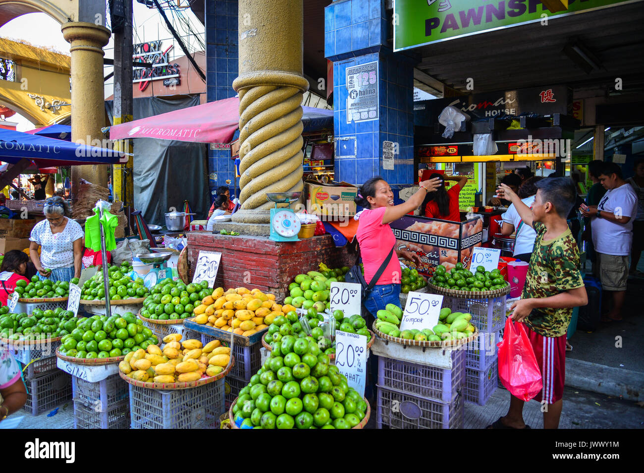 Manila, Philippines Apr 12, 2017. A woman selling fresh fruits at street market in Manila