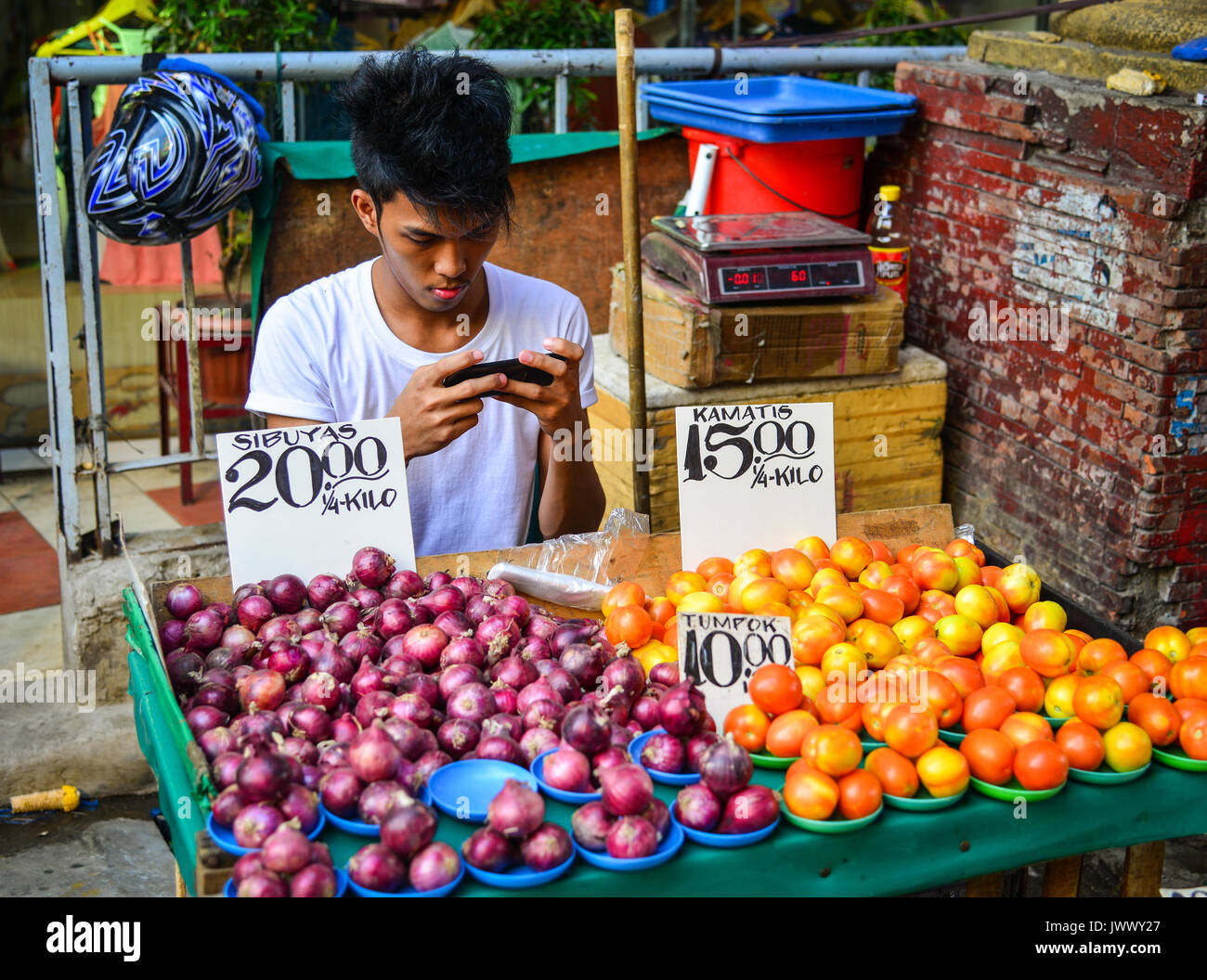 Manila, Philippines Apr 12, 2017. A man selling fruits at street