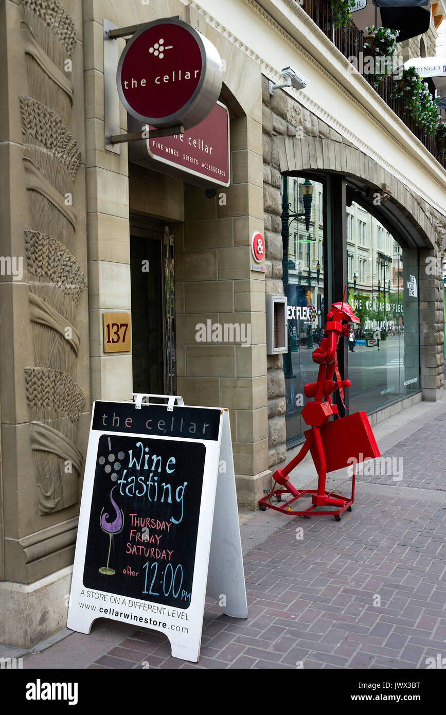 The Cellar Wine Store with Bright Red Metallic Sculpture on 8 Avenue SW in Downtown Calgary Alberta Canada Stock Photo
