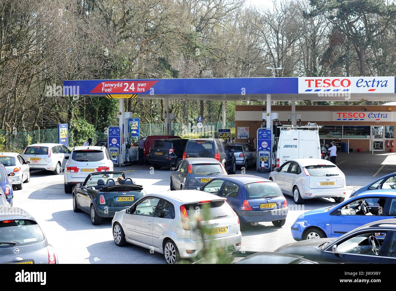Cars queue for petrol and diesel at a busy Tesco Extra petrol station
