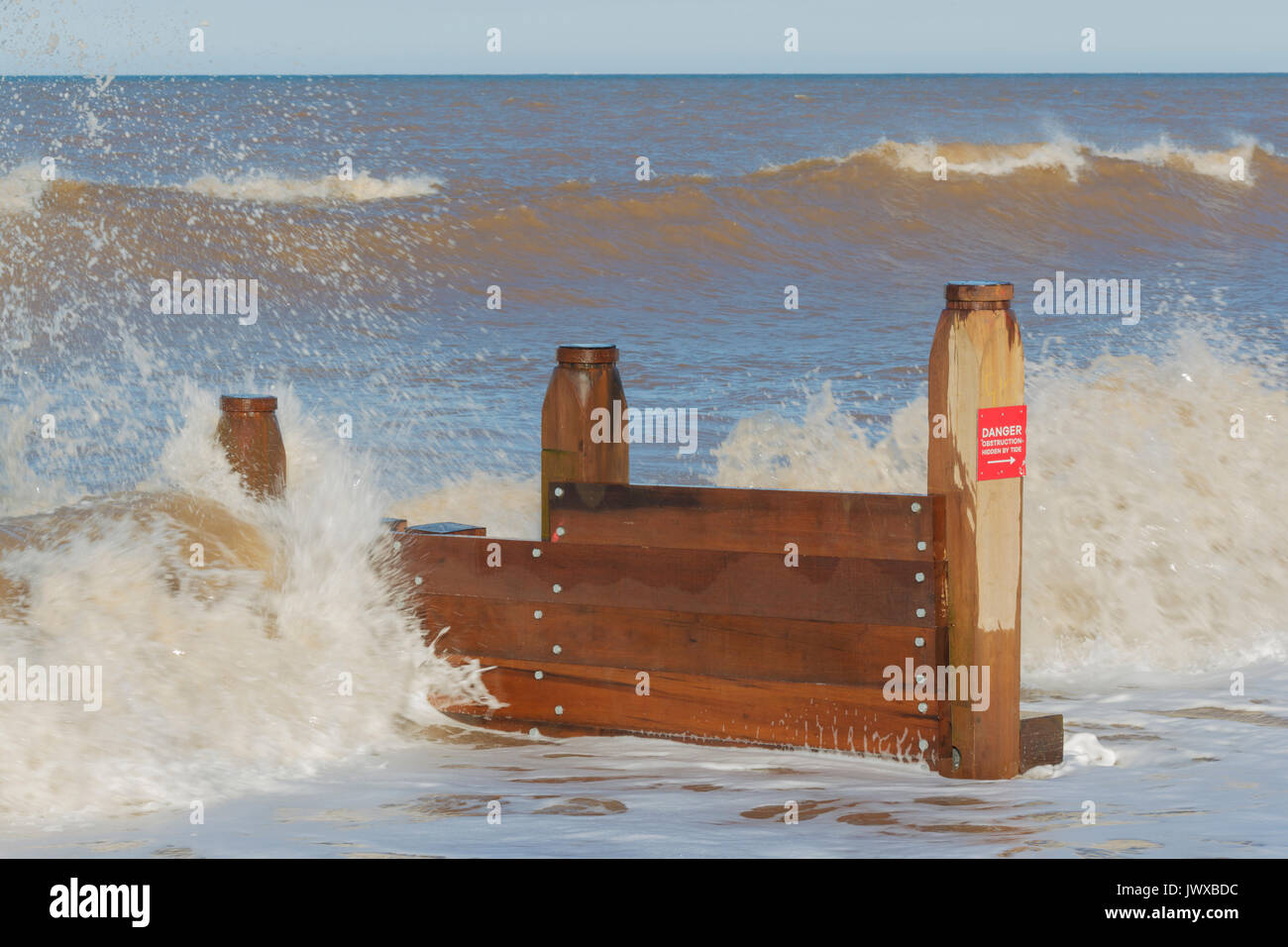 Wooden groynes and waves from tide, Withernsea beach, East Yorkshire,