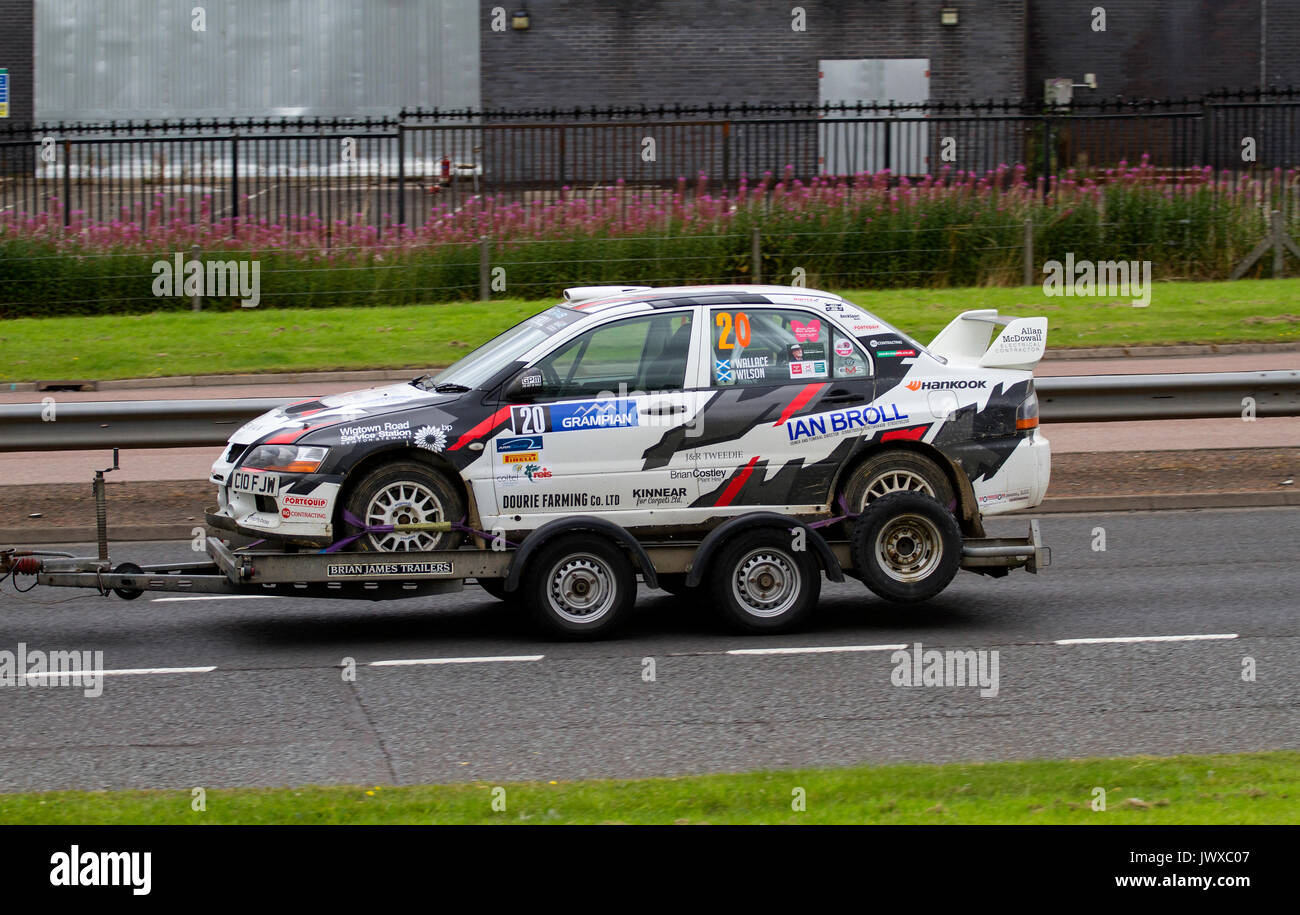 A Fraser Wilson and Craig Wallace Mitsubishi Lancer Evolution (EVO 9) Rally car being towed along the Kingsway West dual carriageway in Dundee, UK Stock Photo
