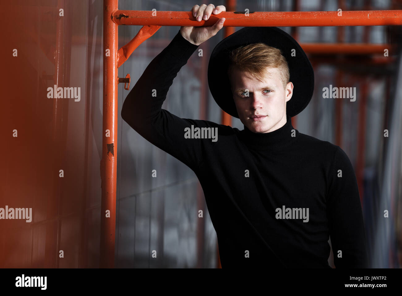 Young man posing with a trendy outfit against a urban background Stock ...