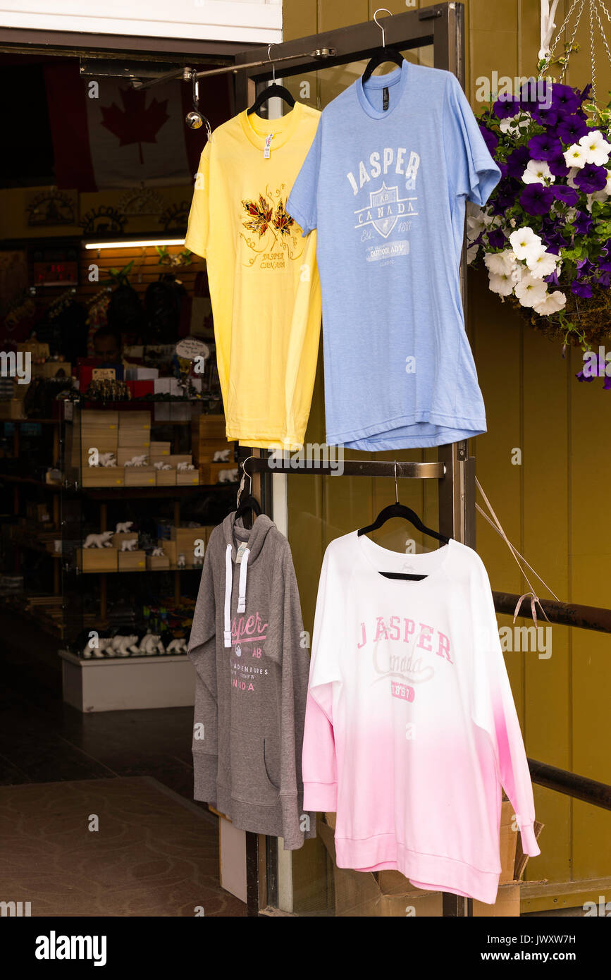 T-Shirts Hanging Up For Sale Outside a Gift and Clothes Shop in Jasper Alberta Canada Stock Photo