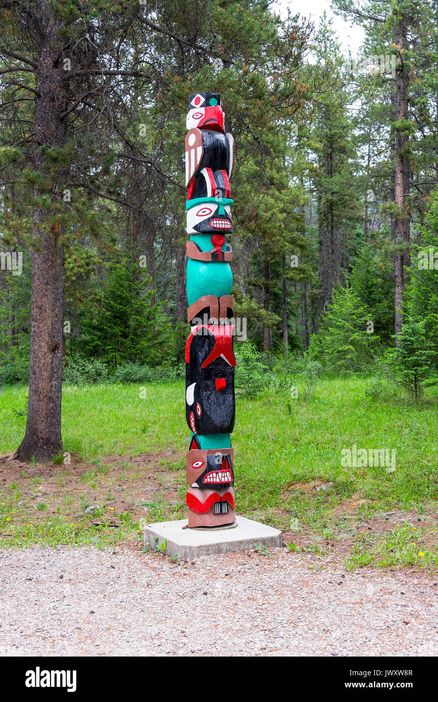 Traditional Carved Totem Pole in the Grounds of Tekarra Lodge Hotel and Cabin Complex near Jasper Alberta Canada Stock Photo