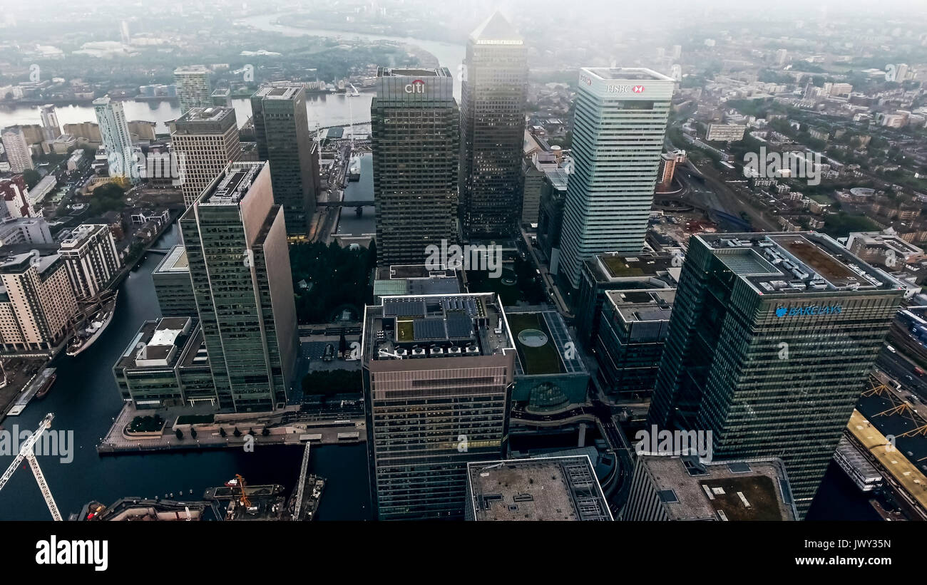 Aerial View Photo of London City Financial District and Skyscrapers in Canary Wharf Helicopter Flight View with Bird's Eye View Business Buildings UK Stock Photo