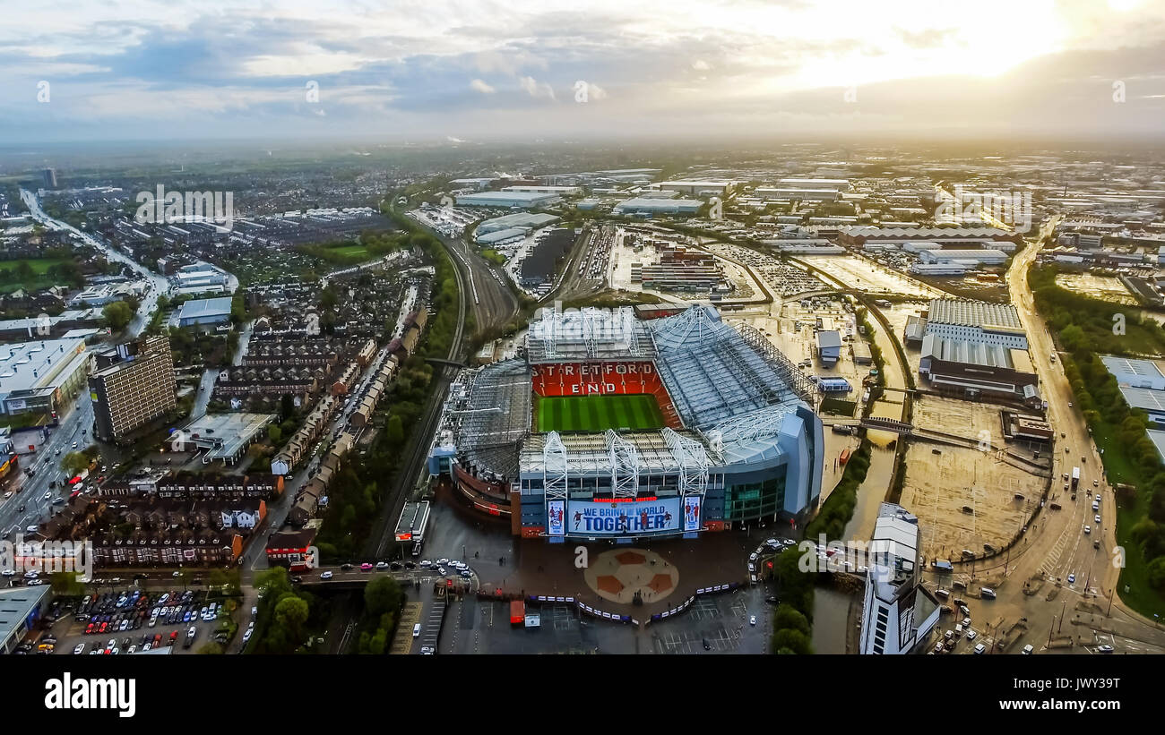 Aerial View Image Photo of Iconic Manchester United Stadium Arena Old Trafford Football Ground Flying Over feat Greater Manchester Cityscape Stock Photo