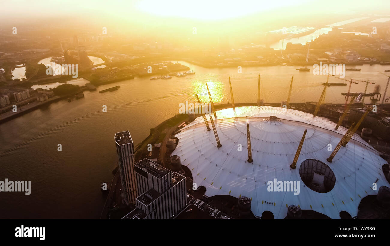 Aerial View Image Photo Flying by London O2 Arena Concert Hall by the River Thames Waterway at Sunrise Dawn Time feat. Amazing Sky 4K Ultra HD Stock Photo