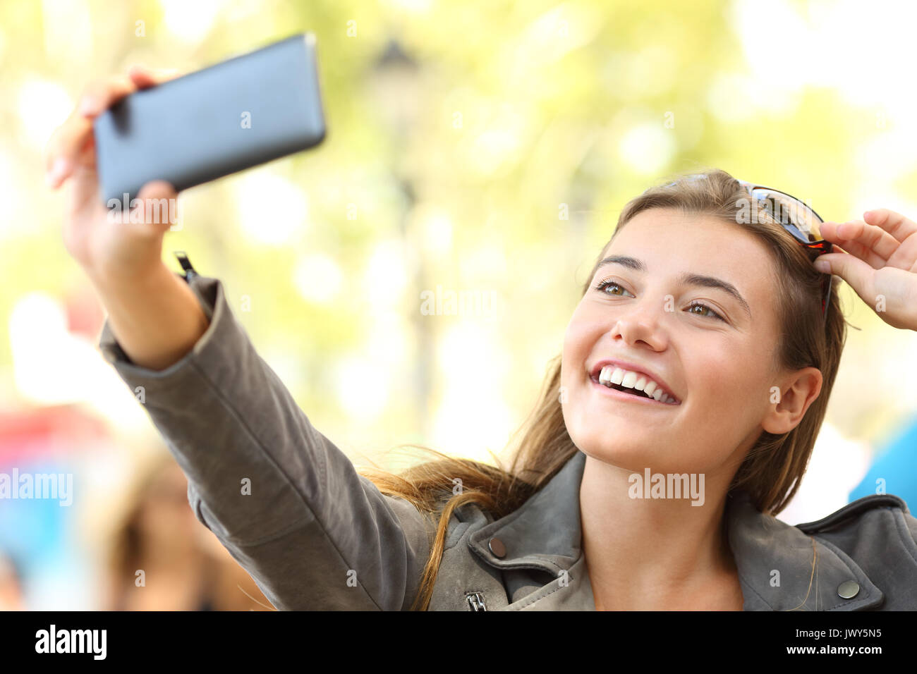 Fashion teen taking selfies with a smart phone on the street Stock Photo
