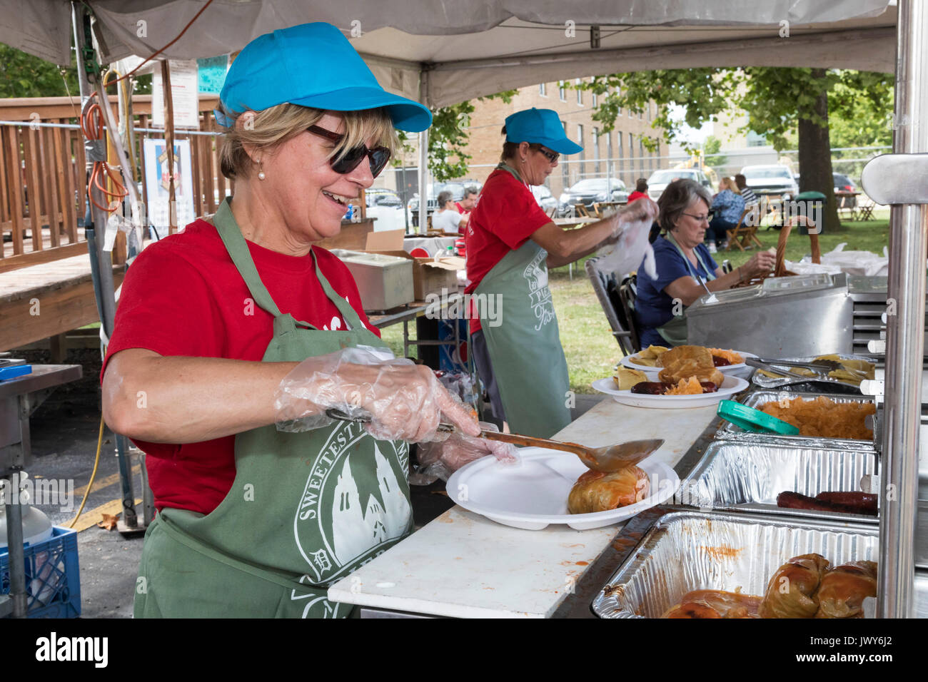 Detroit, Michigan - Kathy McAllum prepares plates of Polish food at the annual Pierogi Festival sponsored by Sweetest Heart of Mary Catholic Church. T Stock Photo