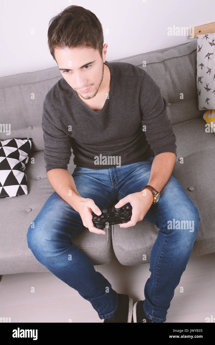 Guy playing video game on couch hi-res stock photography and images - Alamy