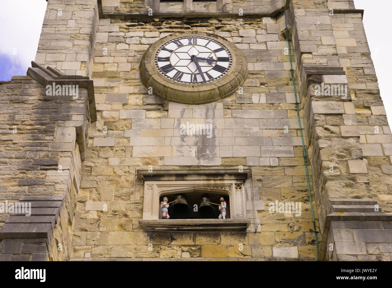 Close up of the Holy Rood church front façade with pre-1760 quarter jacks figures below the clock Stock Photo