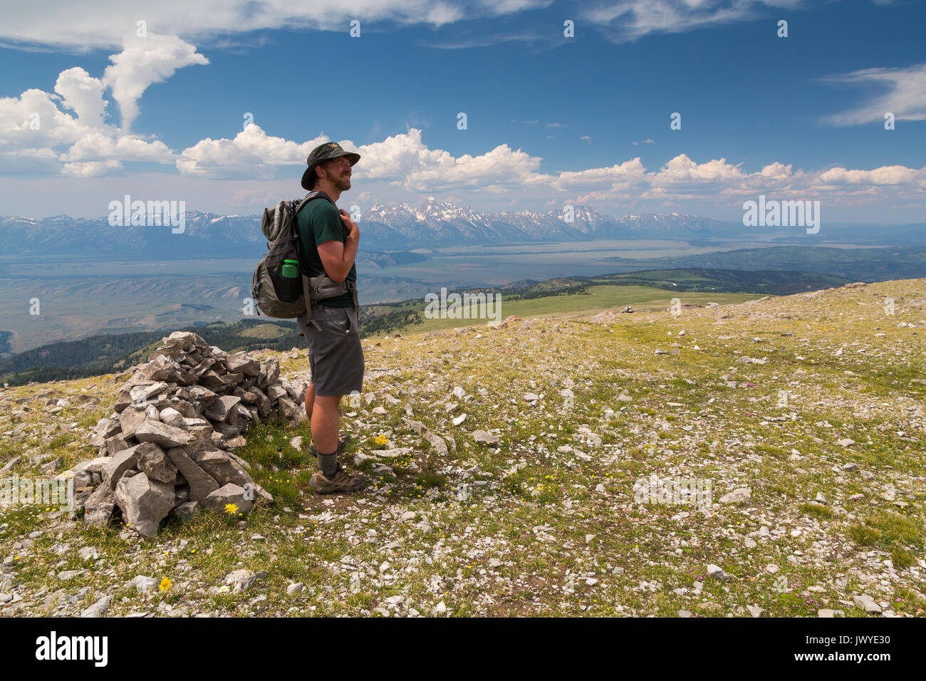 A male hiker standing on the summit of the Sleeping Indian, aka Sheep Mountain. Gros Ventre Wilderness, Wyoming Stock Photo