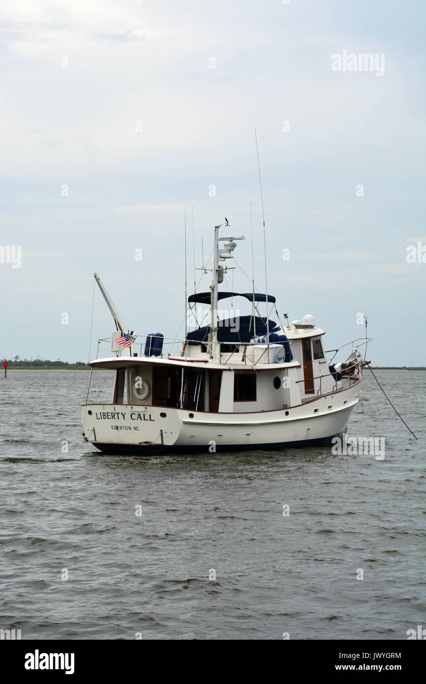 A pleasure boat anchored in Shallowbag Bay off of the town of Manteo on