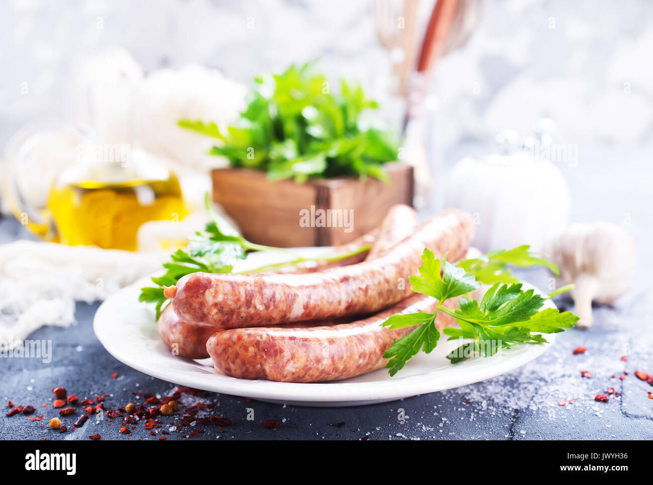 sausages with spice on white plate. stock photo Stock Photo