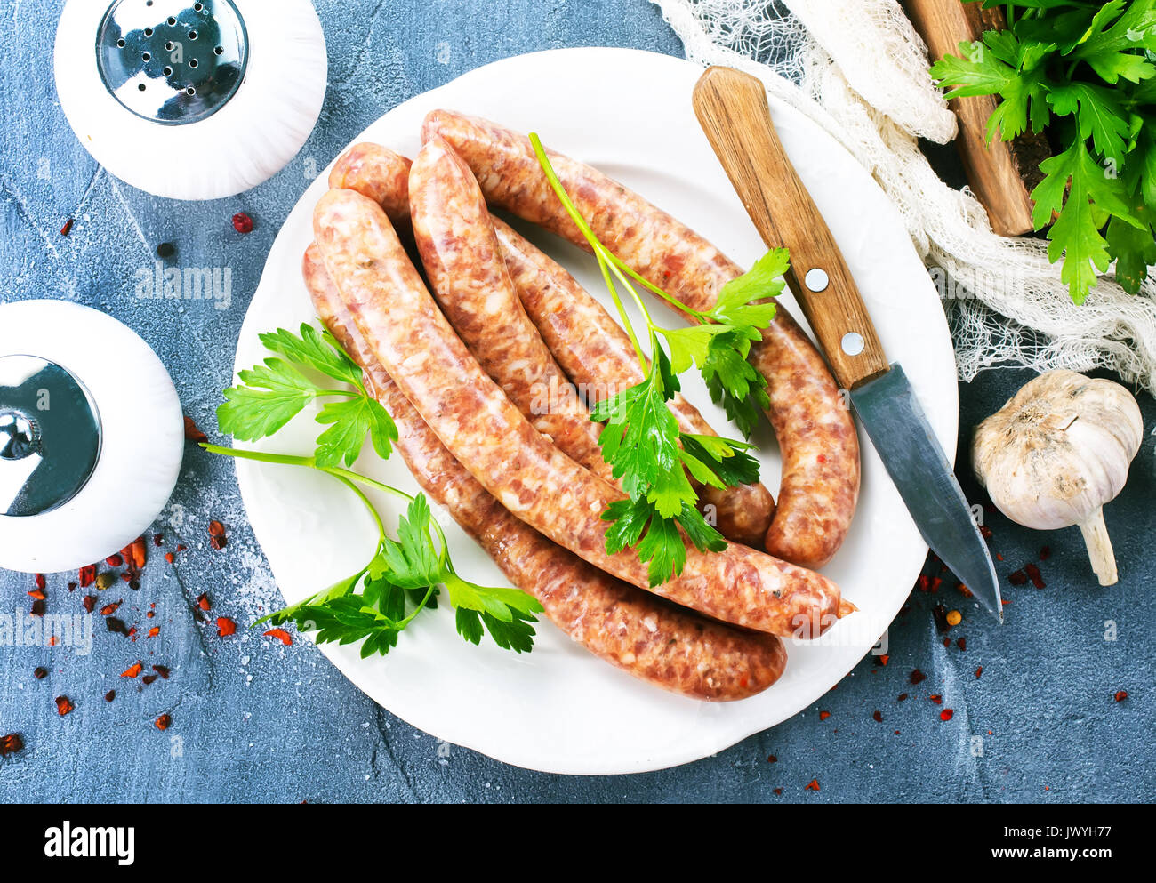 sausages with spice on white plate. stock photo Stock Photo
